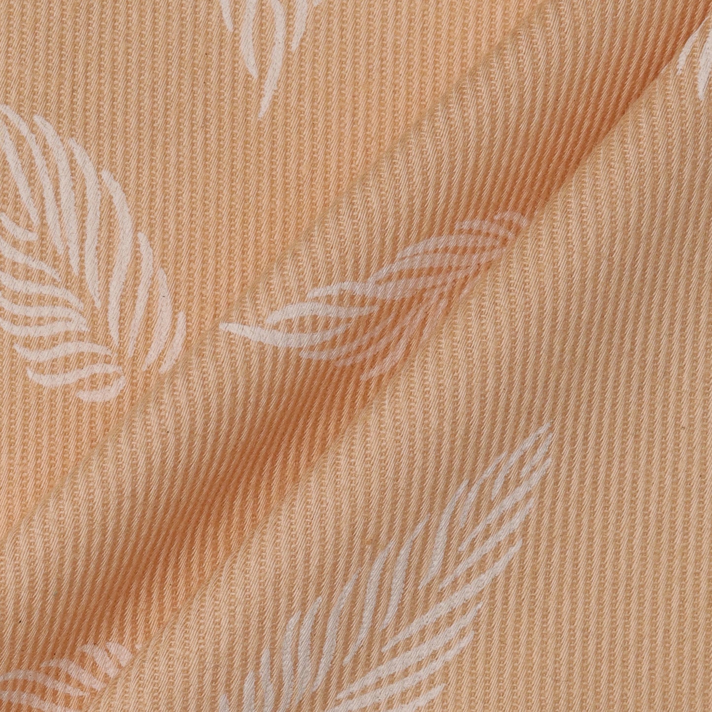 Close-up of beige fabric with subtle leaf pattern