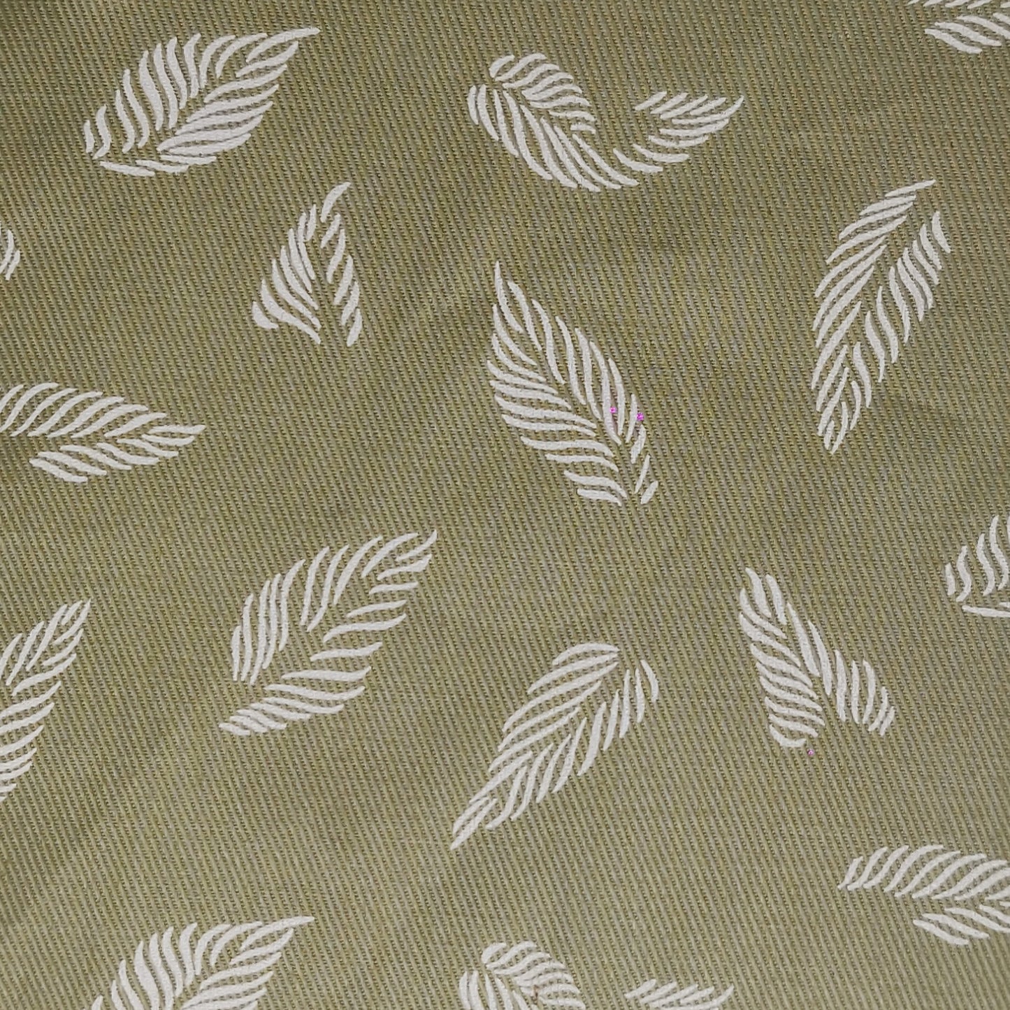 unstitched cotton fabric with pattern of white leaves on a green background
