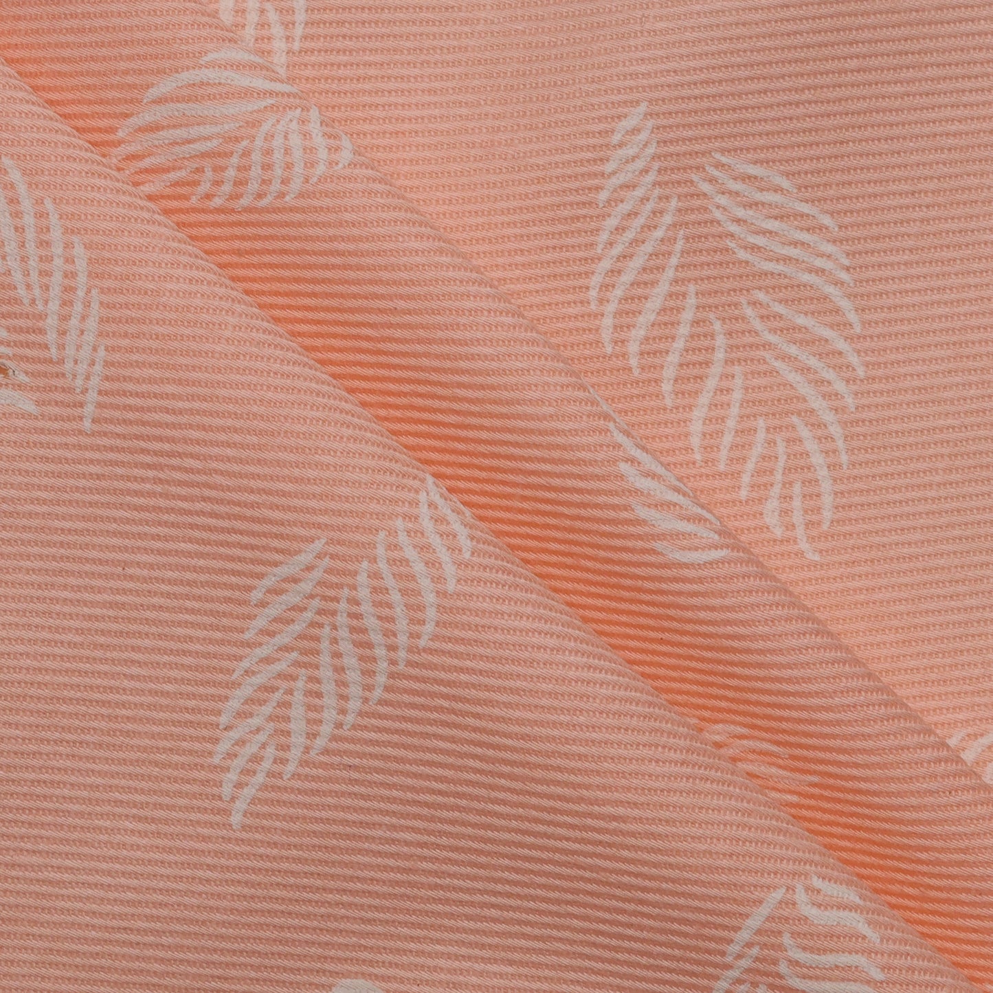 Textured fabric with leaf pattern on a pink background