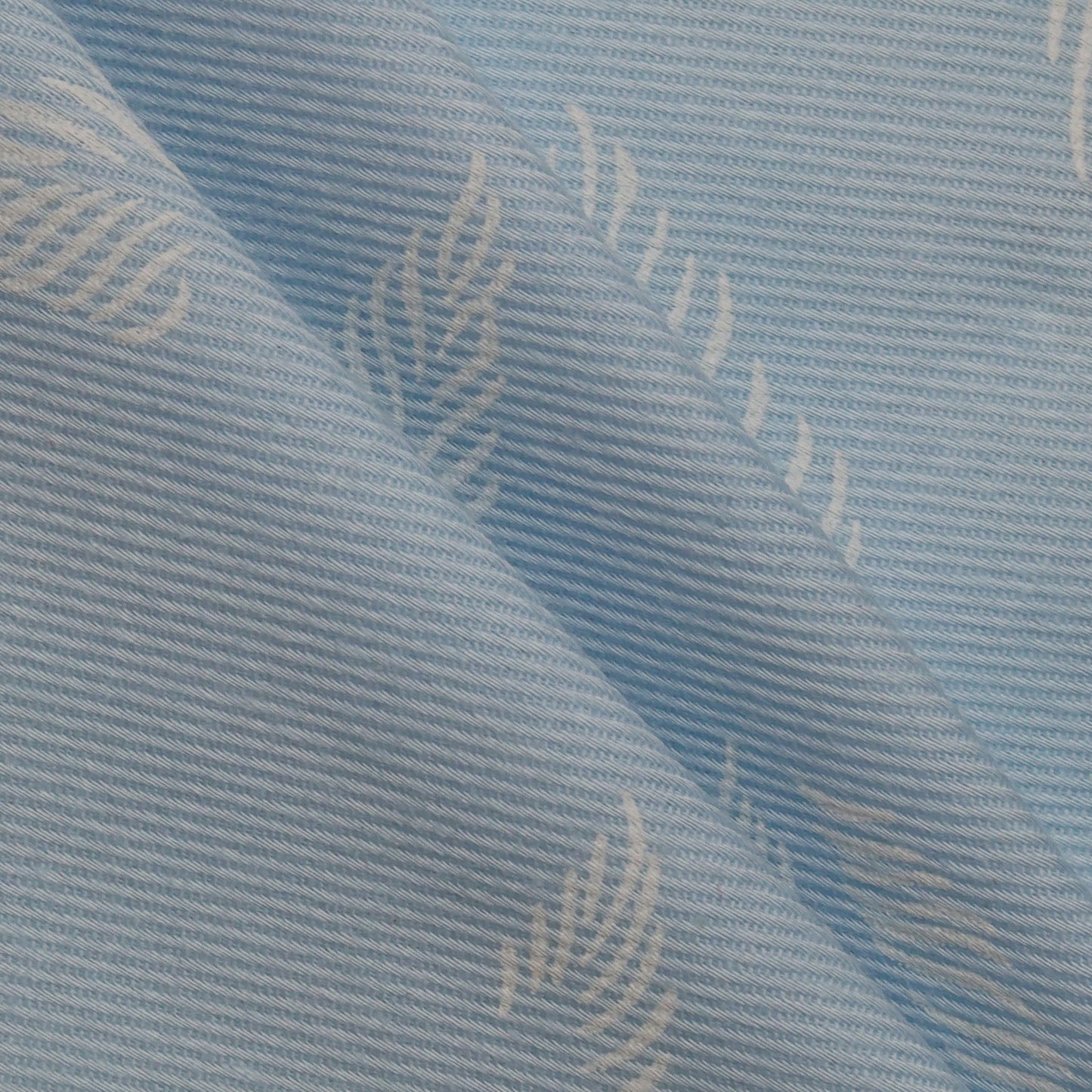 Close-up of textured blue fabric with subtle pattern