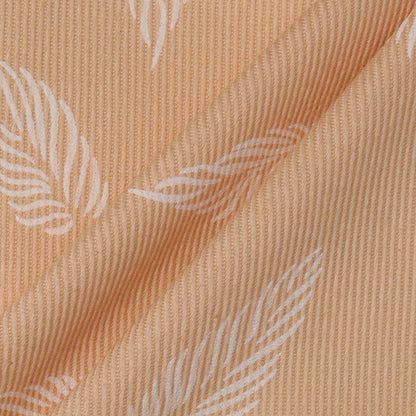 Close-up of beige fabric with subtle leaf pattern