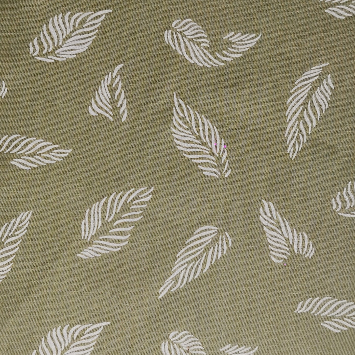 unstitched cotton fabric with pattern of white leaves on a green background