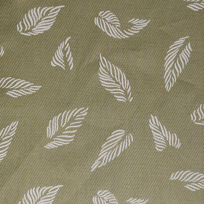 unstitched cotton fabric with pattern of white leaves on a green background